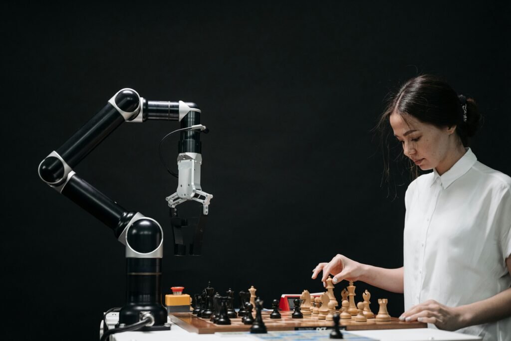 A woman plays chess against a robotic arm, showcasing AI innovation in a modern setting.